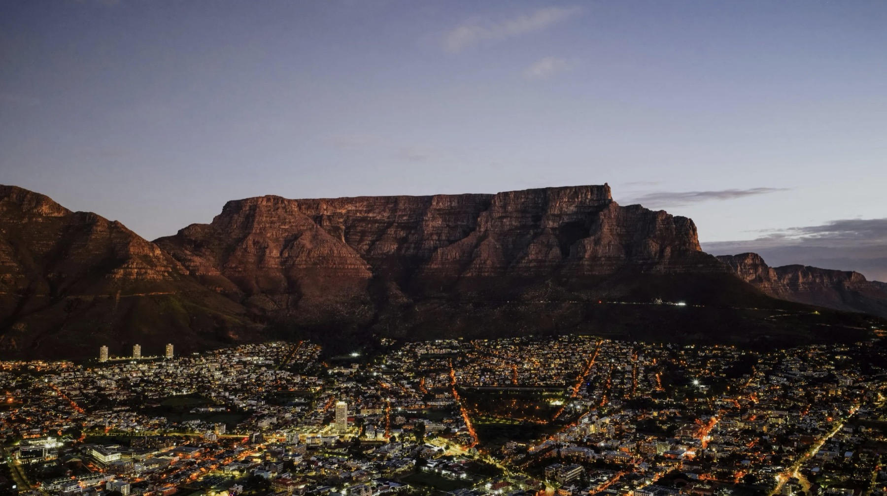 Table Mountain over Cape Town city lights at dusk